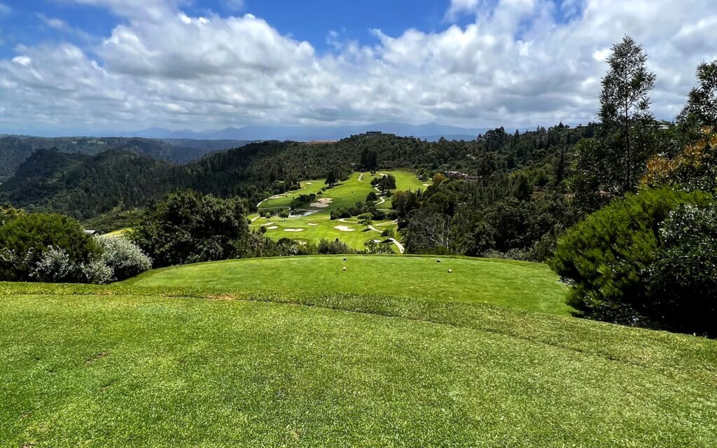 Simola Golf Club, Knysna — Blick vom erhöhten Abschlag auf das Fairway im Tal